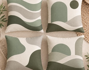 May include: A set of four square scatter cushions featuring a coordinated colour palette of sage green, olive green, grey, and cream. Each cushion displays a distinct abstract pattern, including wavy lines, geometric arches, and organic shapes.