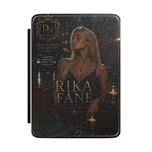 May include: A rectangular e-reader case featuring a dark, textured cover with a gold-toned crest labeled DN COLLECTION and DEVIL'S NIGHT COLLECTION. The cover displays a blonde person in a black dress, the text RIKA FANE, and the quote I SURVIVED WHAT WAS MEANT TO BREAK ME.