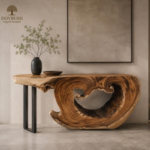 May include: A console table featuring a natural live-edge wood slab with a large, hollowed-out center and a smooth, polished surface. The table is supported by a black metal U-shaped leg on the left side and the wood base on the right.