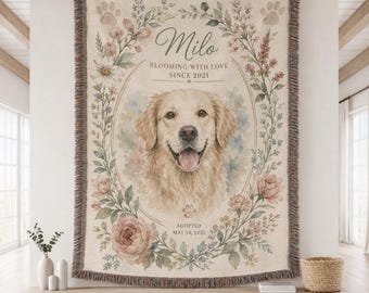 May include: A woven throw blanket featuring a portrait of a golden retriever dog centered within a floral wreath. The text reads Milo, Blooming with love since 2021, and Adopted May 14, 2021. The design includes paw prints and soft watercolor flowers.