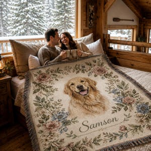 Couple using personalized dog woven blanket in cozy cabin bedroom, custom pet portrait throw with floral border.