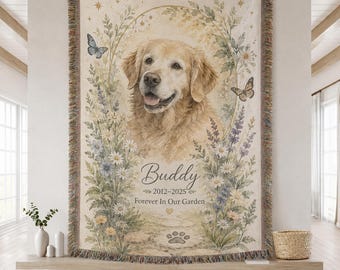 May include: A woven throw blanket featuring a portrait of a golden retriever surrounded by a floral wreath, butterflies, and stars. The text reads Buddy, 2012-2025, and Forever In Our Garden, with a paw print graphic at the bottom center.