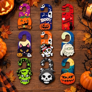 May include: A set of nine Halloween-themed door hangers featuring various designs including pumpkins, skulls, a black cat, a mummy, and a pirate skull. Each hanger displays colorful graphics with text such as BOO, HALLOWEEN, and WILD LIKE A PIRATE.