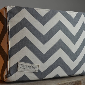 May include: A gray and white chevron patterned fabric storage bin with the text "Chelsea Bag" on the front.