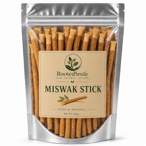 May include: A silver stand-up pouch filled with numerous brown Miswak sticks. The label features the text RootedSmile, PURE, NATURAL, TRUSTED, MISWAK STICK, PURE & NATURAL, and NET WT. 200g, along with a graphic of a plant and a single stick.