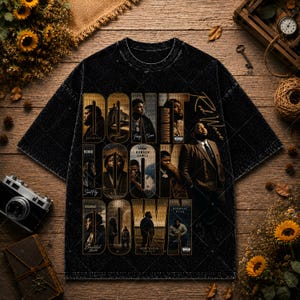 May include: A black acid-wash t-shirt featuring a graphic collage of Rod Wave. The text "DON'T LOOK DOWN" is printed in large gold letters across the center. The design includes multiple photographic portraits and album titles in a grid layout.