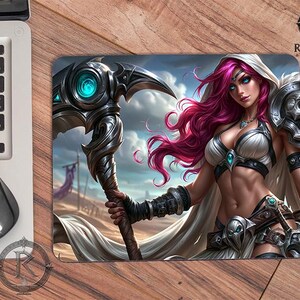 May include: A rectangular mouse pad featuring a fantasy illustration of a character with long magenta hair, wearing white and silver armor, and holding a large, ornate scythe with a glowing teal center. The background depicts a desert landscape.