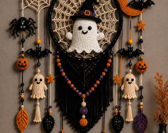 May include: A Halloween-themed wall hanging featuring a central black hoop with a cream-colored crochet web and a white ghost wearing a black hat. It includes dangling crochet elements like pumpkins, bats, spiders, stars, leaves, and ghosts with beads.
