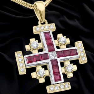 May include: A Jerusalem cross pendant crafted from yellow gold, featuring a central square diamond surrounded by channel-set square-cut red rubies. The cross is accented with round brilliant-cut diamonds along the arms and ends, suspended from a gold chain.
