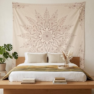 May include: A large rectangular wall tapestry featuring a central mandala design in brown ink on a cream-colored fabric. The intricate pattern consists of radiating floral and paisley motifs, with a decorative border framing the entire piece.