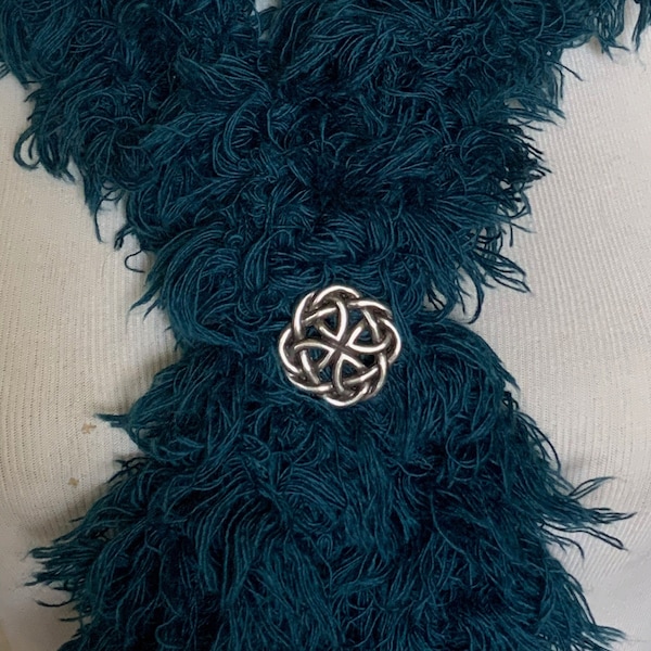 The mattie silver tone flower Celtic scarf/ponytail stretch holder.