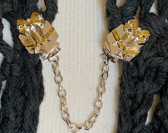 The mattie silver and gold tone wrapped present sweater clip