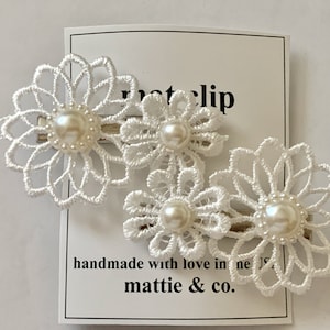 The mattie faux pearl and white embroidered flower clip barrettes