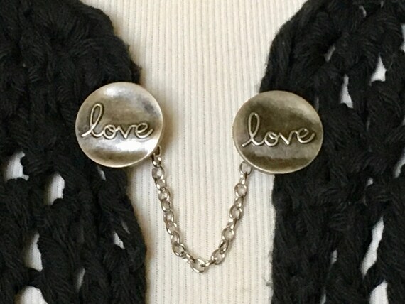The mattie antiqued silver tone metal LOVE sweater clip
