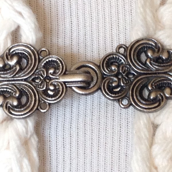 The mattie silver tone metal Celtic swirl sweater clip clasp