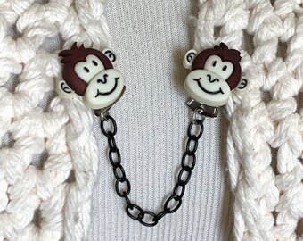 The mattie brown and white smiling monkey sweater clip clasp