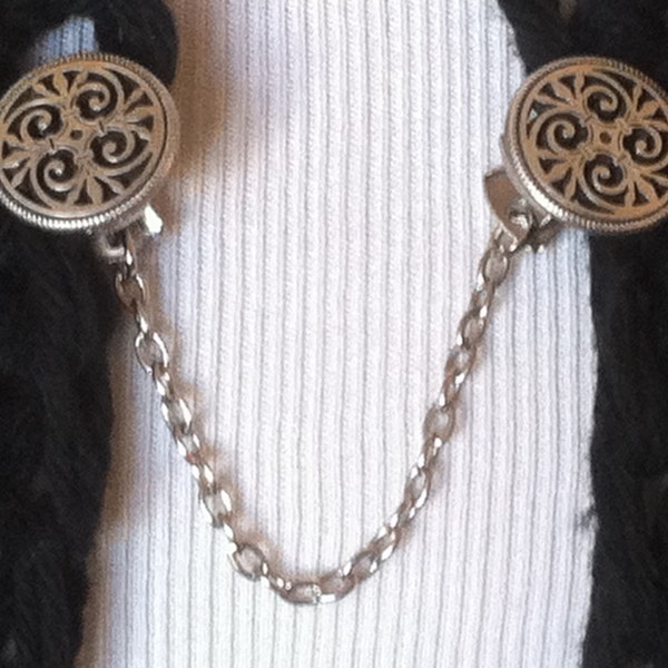 The mattie silver tone metal Celtic circle sweater clip adds a touch of interest to your cover ups.