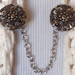 The mattie silver tone resin medallion sweater clip