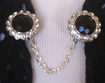 The mattie black  stone and rhinestone circle sweater clip adds a touch of drama to your wardrobe
