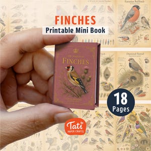 May include: A miniature book titled The World of Finches with a dusty rose cover featuring a gold crown icon and a gold illustration of a goldfinch perched on a branch. The book cover includes the text Floral Heritage Collection.