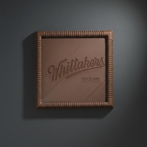 May include: A square, brown chocolate bar with a ribbed border. The centre features the embossed text Whittakers and the year SINCE 1896. The surface has a diagonal brushed texture, and the chocolate is presented against a dark grey background.