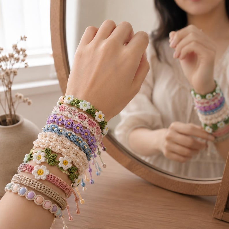 May include: A stack of multiple handmade crochet bracelets featuring various designs, including white daisy flowers with yellow centers, green leaves, and pastel-colored beads. The bracelets are crafted with intricate yarn patterns in shades of green, pink, purple, blue, and cream.