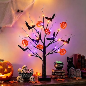 May include: A black decorative tree with thin branches illuminated by small purple and orange LED lights. The tree features hanging orange jack-o'-lantern ornaments and black bat silhouettes. It stands on a square base, creating a festive display.