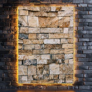 May include: A rectangular wall panel featuring a textured, multi-tonal beige and tan stone veneer. The panel is framed by a continuous, warm yellow LED light strip, set against a dark, charcoal-coloured brick wall background.