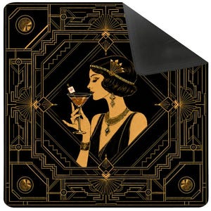 May include: A square mat featuring a black and gold art deco geometric border. The center displays a profile illustration of a person with a bob haircut, wearing a headband and jewelry, holding a martini glass with a small mahjong tile garnish.