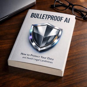 May include: A white book titled Bulletproof AI: How to Protect Your Data and Aveid Legal Landmines, featuring a large, metallic, silver-toned shield graphic on the cover. The book is positioned near a pair of black-rimmed eyeglasses and a laptop.