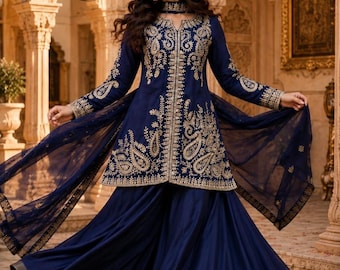May include: A deep navy blue long-sleeved tunic and wide-leg trousers set featuring intricate gold embroidery along the front, neckline, and sleeves. The outfit includes a matching sheer navy blue dupatta with a gold embroidered border.