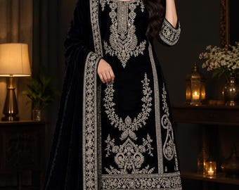 May include: A black velvet three-piece outfit featuring a long-sleeved tunic, matching trousers, and a shawl. The tunic and shawl are adorned with intricate silver embroidery along the neck, cuffs, hem, and borders of the fabric.