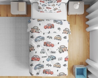 May include: A white single bed set featuring a repeating pattern of cartoon race cars, including red, blue, and orange vehicles, checkered flags, lightning bolts, and the number 95. The bedding includes a duvet cover and a matching pillowcase.