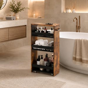 May include: A tall, narrow, rolling storage cart with a rustic brown wood-grain finish and three black metal shelves. The cart features a top handle and small wheels at the base, holding various bottles, containers, and rolled white towels.