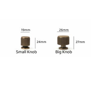 May include: Two cylindrical brass-toned metal knobs with vertical ribbed textures. The small knob measures 19mm in diameter and 24mm in height. The big knob measures 26mm in diameter and 27mm in height. Both feature a flat top and a circular base.