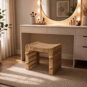 May include: A light-colored wooden stool featuring a curved seat and a slatted, open-frame design. The stool has four vertical legs connected by horizontal slats, creating a structured, grid-like appearance with a natural wood grain finish.