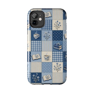 May include: A smartphone case featuring a blue and white patchwork quilt pattern. The design includes alternating squares of gingham, polka dots, and stripes, interspersed with illustrations of open books, steaming teacups, and floral sprigs.