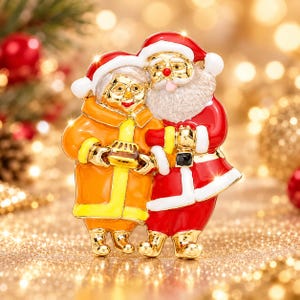 May include: A gold-tone metal brooch featuring Santa Claus and Mrs. Claus standing together. Santa wears a red suit with white trim and a matching hat. Mrs. Claus wears an orange coat with yellow trim and a red hat. They hold a small brown pie.