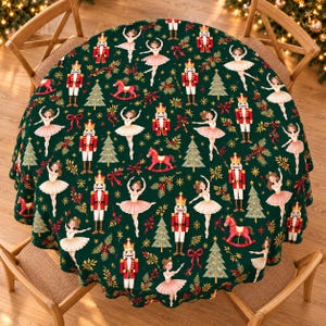 May include: A round tablecloth featuring a dark green background with a repeating pattern of nutcrackers, ballerinas in pink tutus, rocking horses, Christmas trees, red bows, and gold foliage accents across the entire fabric surface.