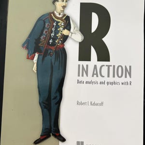 May include: The book titled R IN ACTION, Second Edition, by Robert I. Kabacoff, features a large black letter R on a white background. An illustration of a person in traditional attire with a red cap, blue vest, and blue trousers is on the left.
