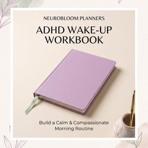 May include: A lavender hardback workbook titled NEUROBLOOM PLANNERS ADHD WAKE-UP WORKBOOK with the subtitle Build a Calm & Compassionate Morning Routine. The book features a light green ribbon bookmark and is placed next to a gold pen in a holder.
