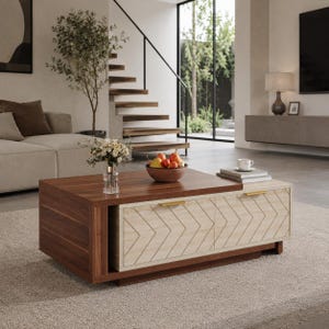 May include: A rectangular coffee table featuring a dark walnut wood finish on the left side and a light oak wood finish on the right side. The light section includes two drawers with gold-toned handles and a chevron pattern on the front panels.