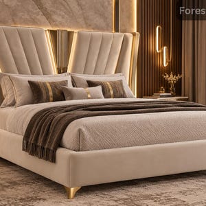 Può includere: Una struttura letto imbottita color beige con un'alta testiera trapuntata verticalmente dotata di illuminazione verticale integrata. Il letto è rivestito con biancheria color beige chiaro, cuscini decorativi marrone scuro e un plaid marrone scuro con piedini dorati.