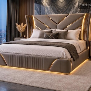 May include: A taupe upholstered bed frame featuring a high, geometric-patterned headboard with integrated warm LED lighting strips, a matching footboard with vertical channel tufting, and a white and brown bedding set with multiple pillows.