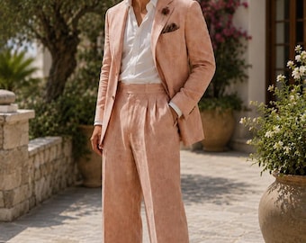 May include: A peach-colored suit consisting of a single-breasted blazer with a notched lapel and matching pleated trousers with cuffed hems, worn over a crisp white button-down shirt, paired with tan loafers and round-frame sunglasses.