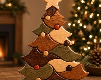 May include: A decorative wooden Christmas tree sculpture composed of interlocking pieces in varying shades of brown, tan, and muted green. The tree is topped with a light-colored wooden star and features small, round, colored wooden spheres.