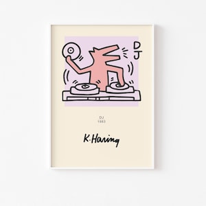 May include: A rectangular art print on a cream background featuring a pink cartoon figure DJing with two turntables and a record. The text DJ, 1983, and the signature K. Haring are printed in black. The central illustration is set against a light purple square.
