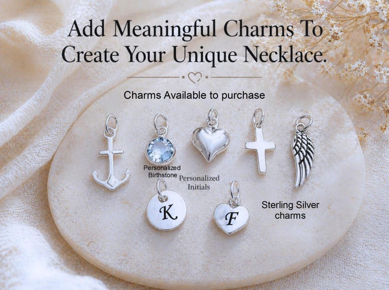 May include: A collection of seven silver-toned charms including an anchor, a light blue crystal, a heart, a cross, a wing, and two circular and heart-shaped discs engraved with the letters K and F. Text reads: Add Meaningful Charms To Create Your Unique Necklace.