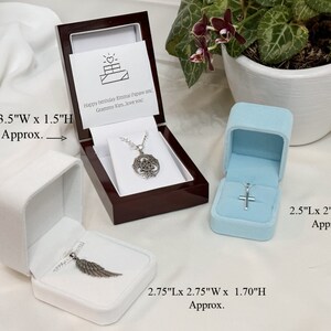 May include: Three velvet jewelry boxes with silver necklaces inside. The boxes are white, light blue, and dark brown. The largest box is 4 inches long, 3.5 inches wide, and 1.5 inches high. The medium box is 2.75 inches long, 2.75 inches wide, and 1.70 inches high. The smallest box is 2.5 inches long, 2 inches wide, and 2 inches high.