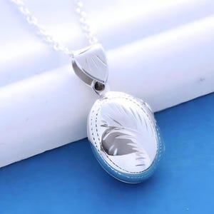 Small Oval Lockets. Solid 925 Sterling silver Locket -Two pictures locket Fancy design (Locket in video R:14). R-13